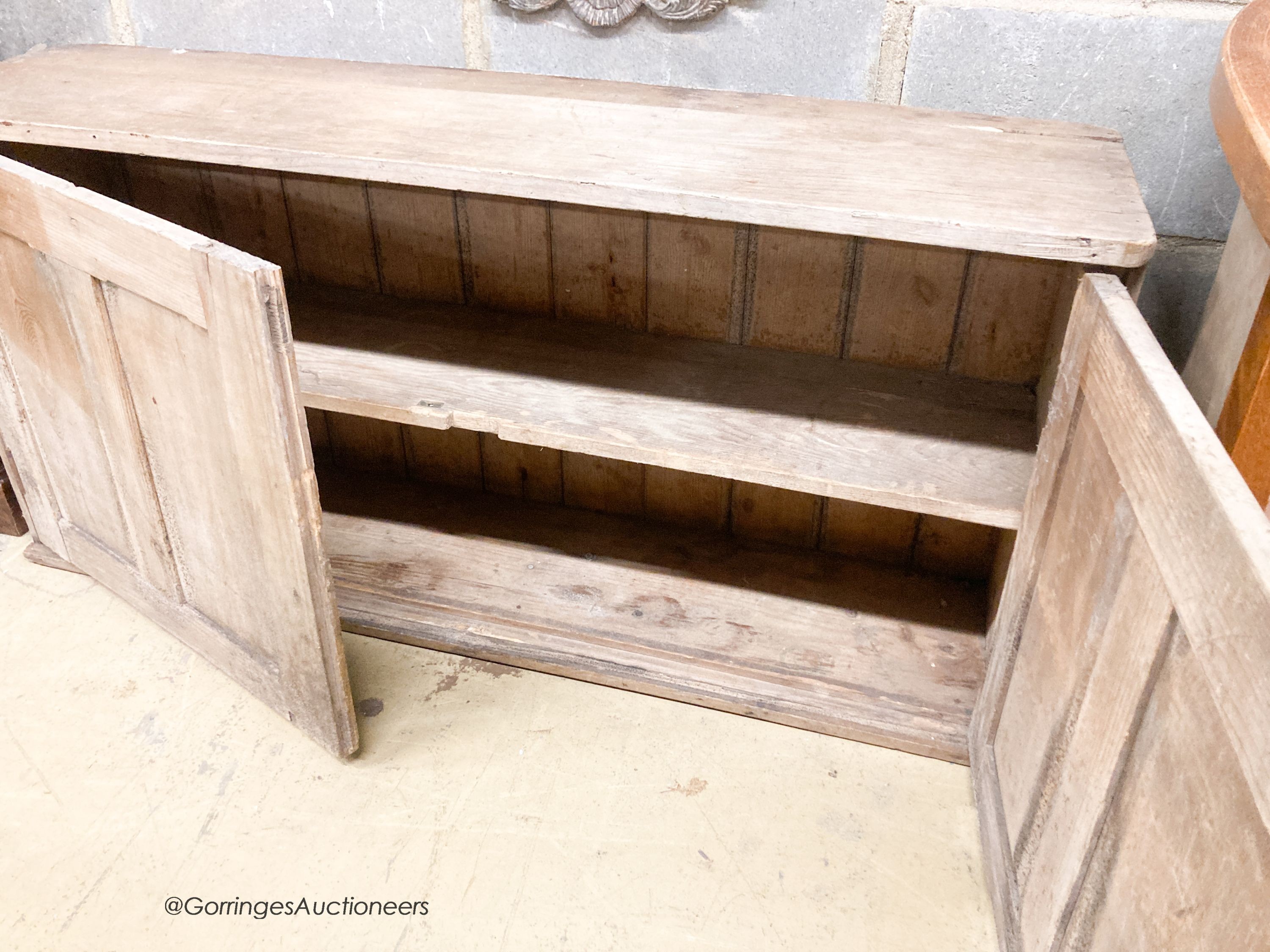 A Victorian pine two door low cupboard, width 122cm, depth 32cm